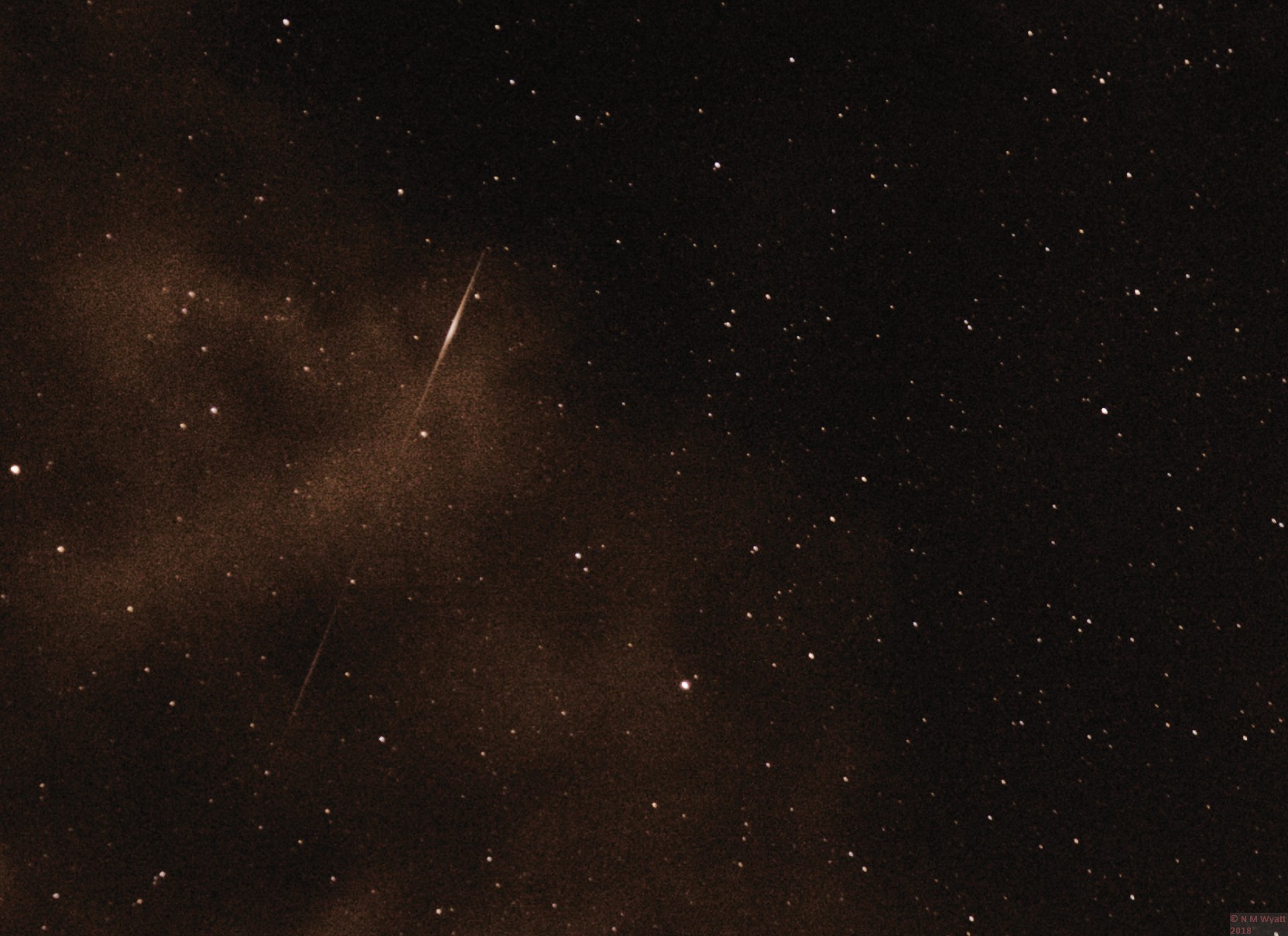 A Perseid meteor seen through light cloud